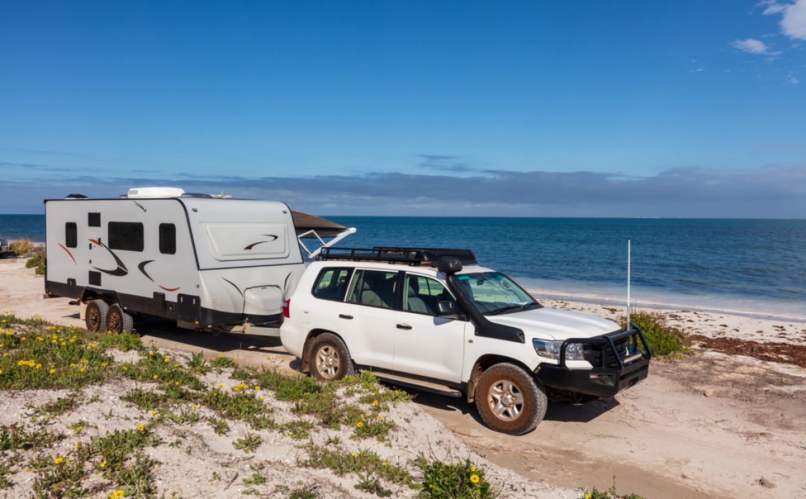 Landscape,Aerial,View,Of,4wd,And,Modern,Caravan,Parked,Adjacent